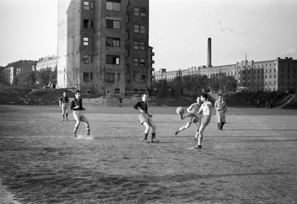 Sportpálya a mai Baranyai tér helyén, háttérben az Október huszonharmadika (Schönherz Zoltán) utca 17. számú ház és a Lágymányosi dohánygyár épülete látható, 1953. Forrás: Fortepan / FŐMTERV