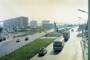 Budaörsi út, szemben az Osztapenko szobor a Balatoni út és az M1-M7 közös szakaszának találkozásánál. Balra az épülő Őrmezői lakótelep, 1975. Forrás: Fortepan / UVATERV